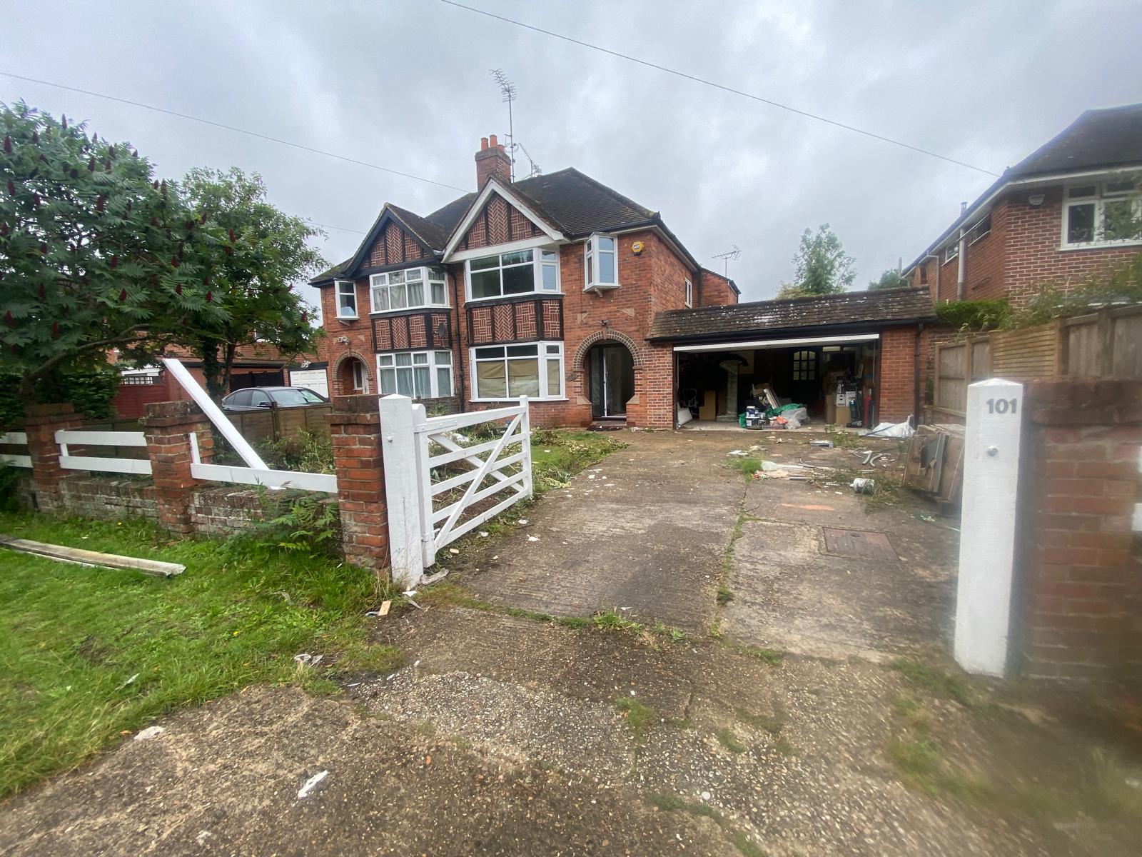 Overgrown front garden and crumbling drive of a 1930s Tudor semi before SIB Construction works