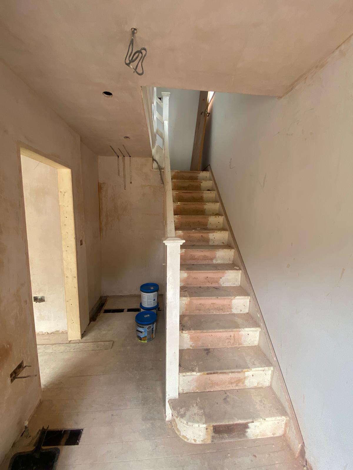 Stripped-back hallway and bare staircase mid-renovation by SIB Construction in Reading