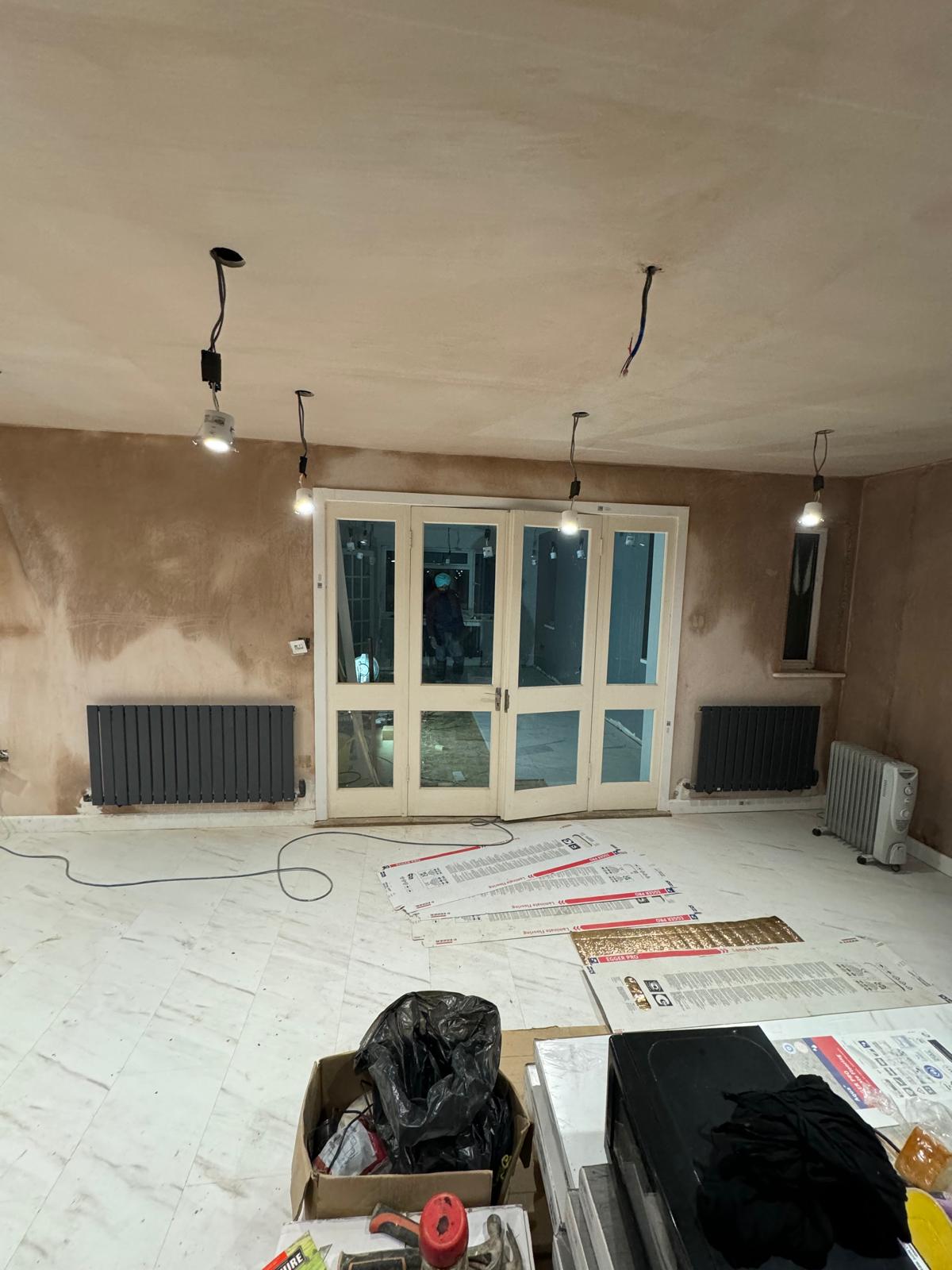 Newly plastered rear extension shell with bi-fold doors before kitchen fit-out by SIB Construction