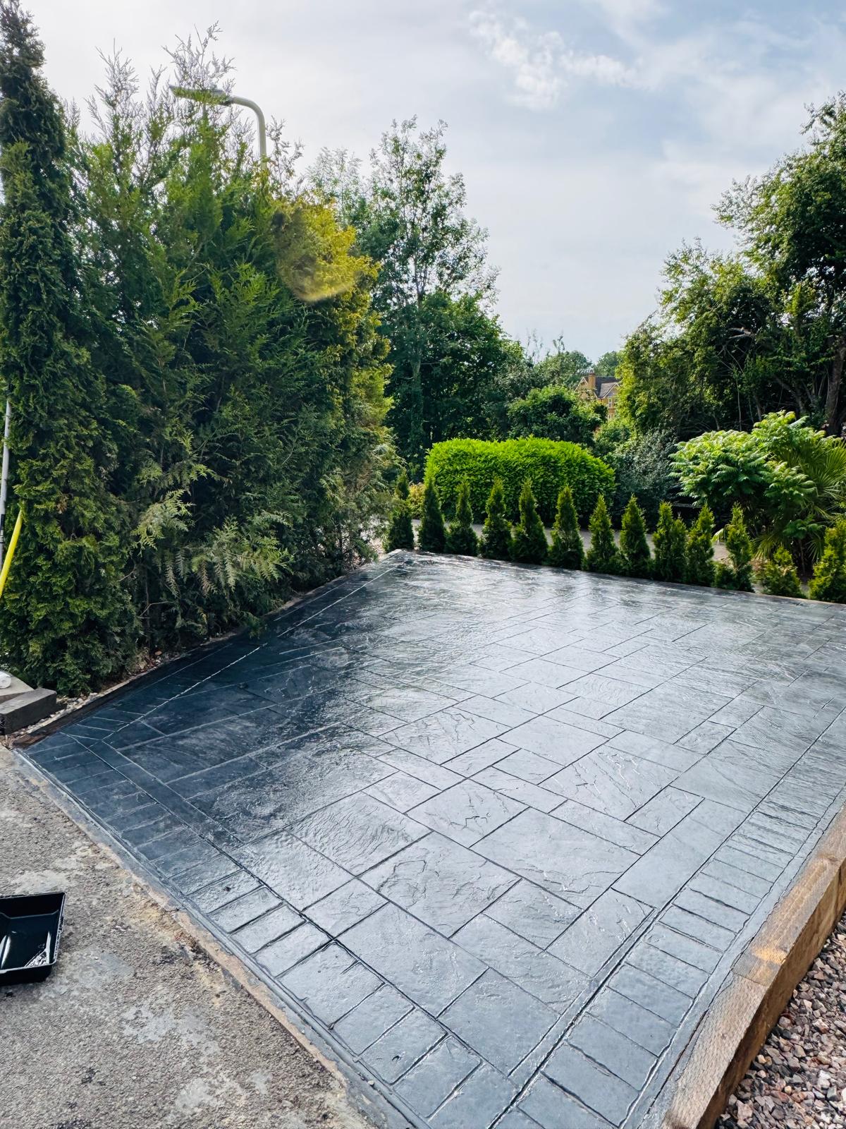 Finished slate-grey pattern-imprinted concrete patio by SIB Construction in Reading, Berkshire